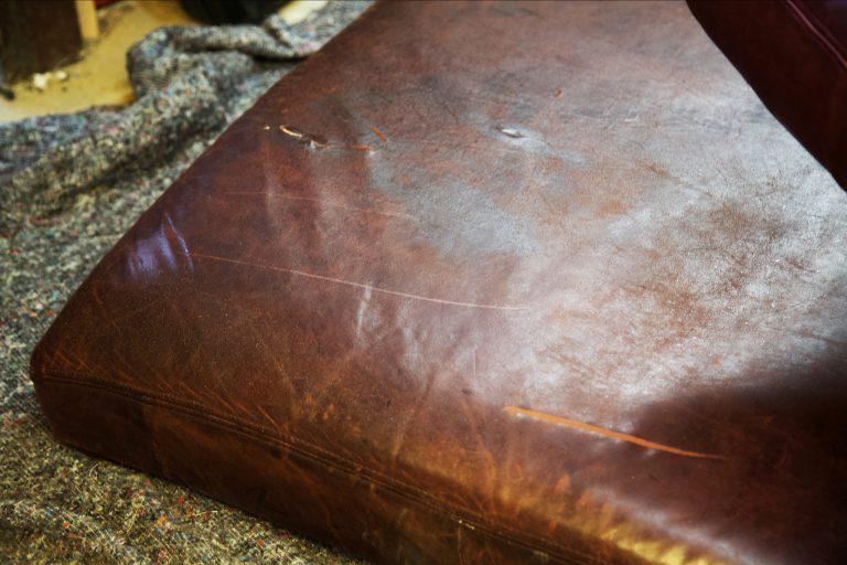 Close up of tears and scratches on leather cushion
