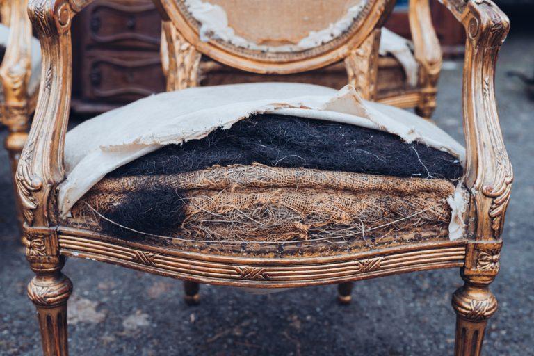 Worn and torn seating of antique chair