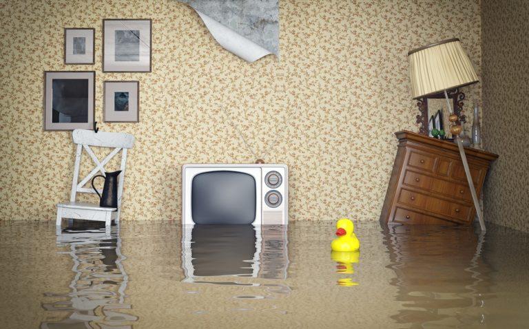 Living room furniture submerged in flood water