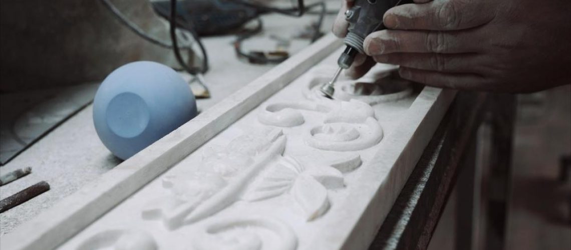engineer engraver working on a marble ornament plate